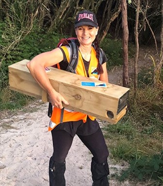 volunteer installing predator trap from Give a Trap